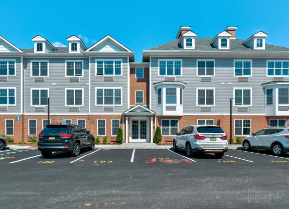 a parking lot in front of a large apartment building at Solo at North Bergen, North Bergen