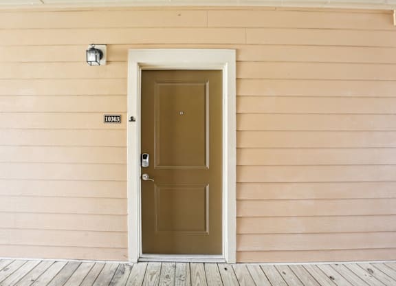 the front door of a house with a brown door