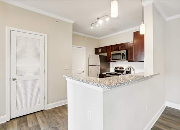 a kitchen with a granite counter top and a refrigerator