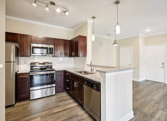 a kitchen with wooden cabinets and stainless steel appliances