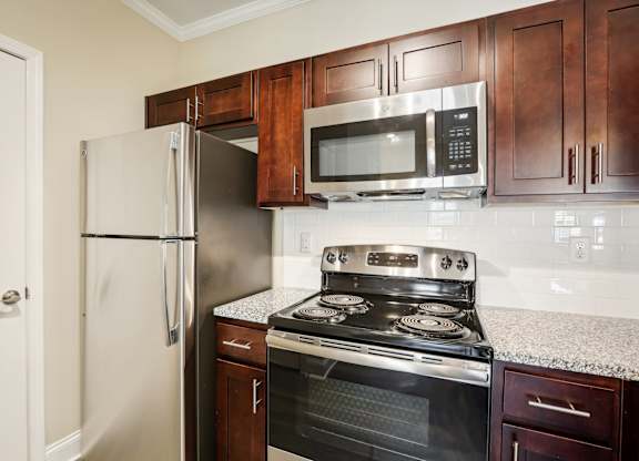 a kitchen with a stove microwave and refrigerator