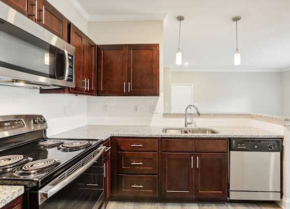 a kitchen with wooden cabinets and appliances and a counter top