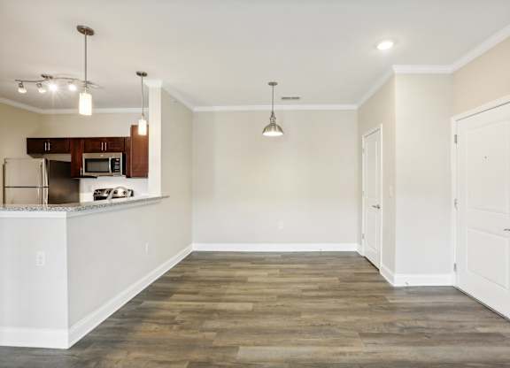 a renovated living room with white walls and wood flooring