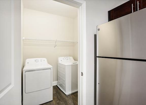 a white washer and dryer in a room with a refrigerator