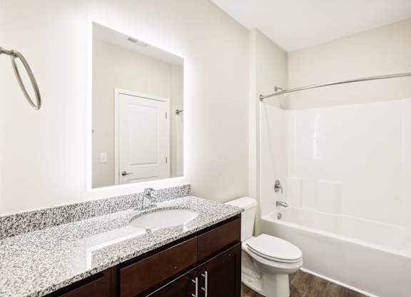 a bathroom with a sink toilet and shower