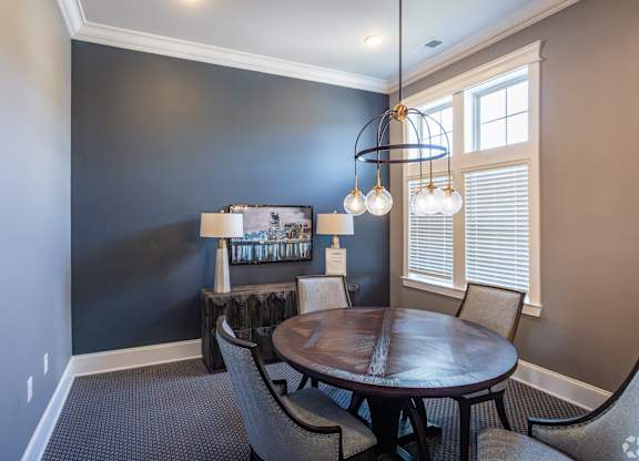 a dining room with a table and chairs and a chandelier
