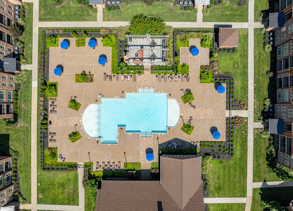 an overhead view of a building with a pool in the middle