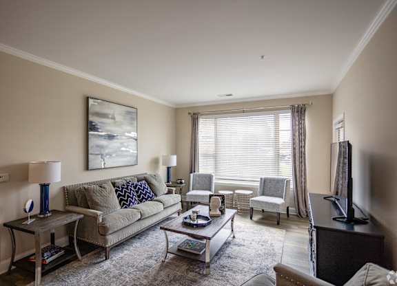a living room with a couch and chairs and a table
