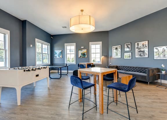 Resident lounge and game room with seating and entertainment space at The Rail North Bergen apartments