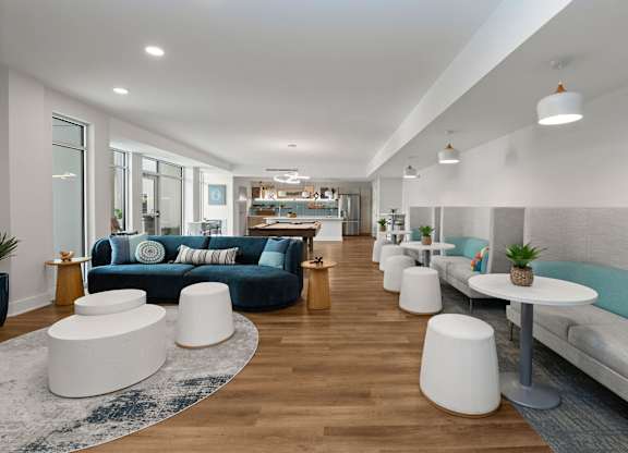 A modern living room with a long couch and a white coffee table.