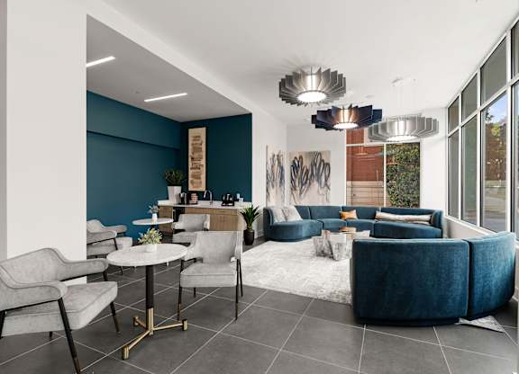 A modern living room with a grey sofa and a white coffee table.