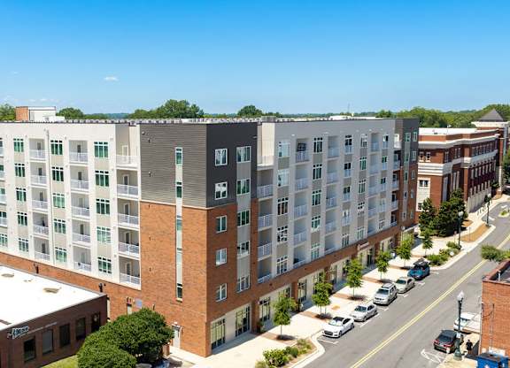A large multi-story building with a parking lot in front.
