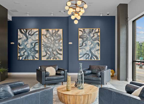A living room with a blue carpet and a wooden coffee table.