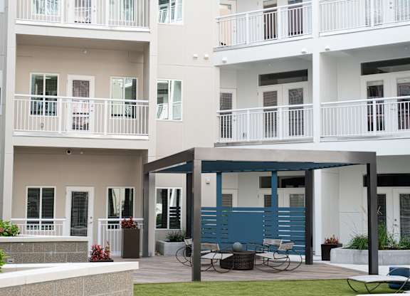 A white building with blue trim and a balcony.