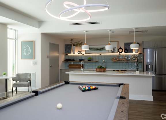 A pool table with a white ball on it.