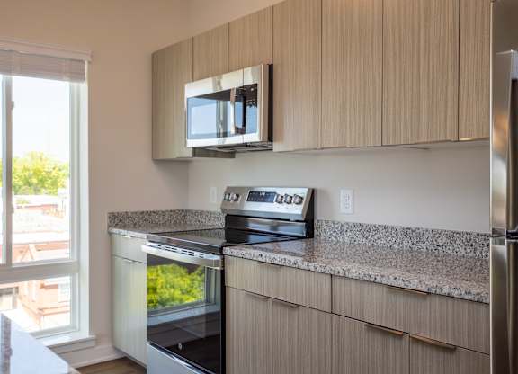 Modern kitchen with stainless steel appliances at NOVI at Concord.