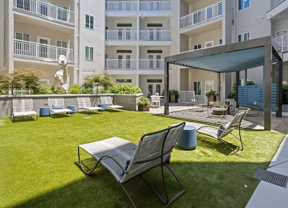A sunny day at the outdoor seating area of a modern apartment complex.