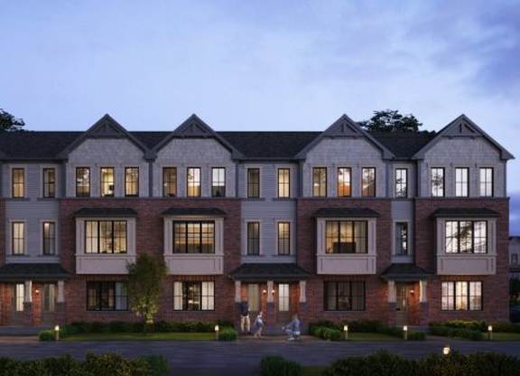 A large, well-lit building with multiple windows and lights on the ground.