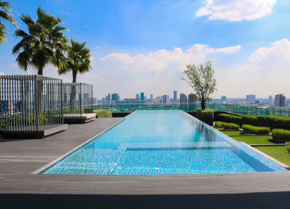 the infinity pool on the roof of a skyscraper overlooking the city