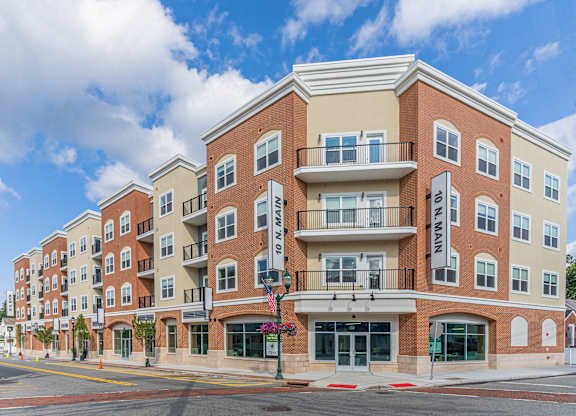 A large apartment building with a balcony on the second floor at 10 N. Main Apartments, Wharton, New Jersey
