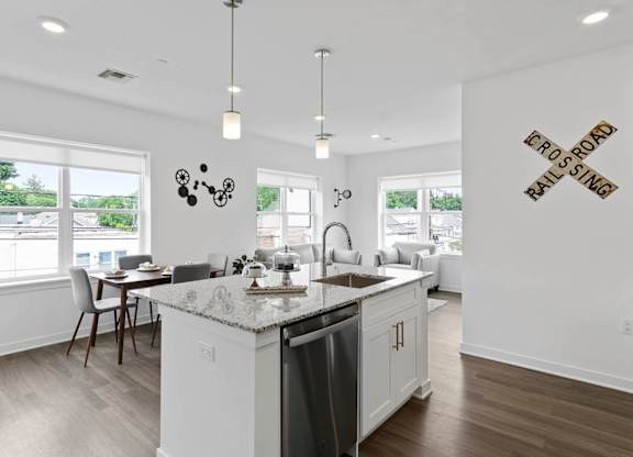 A kitchen with a granite counter top and a sink at 10 N. Main Apartments, Wharton 07885