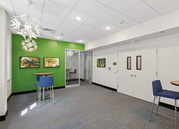 A room with a green wall and a white ceiling.