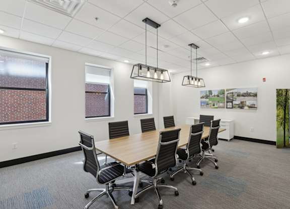 A conference room with a long table and chairs.