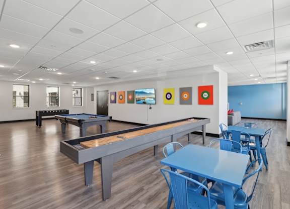 A room with a pool table and a ping pong table.
