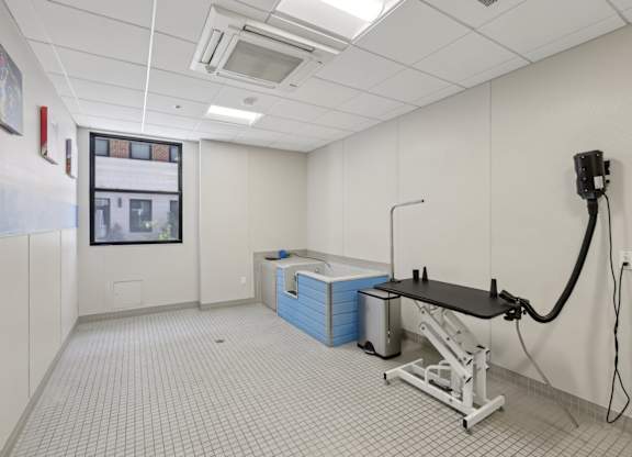 A room with a tiled floor and a table with a black top.