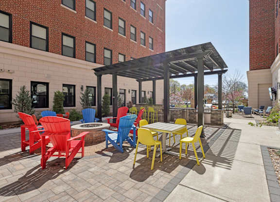 A patio with a table and chairs under a roof.