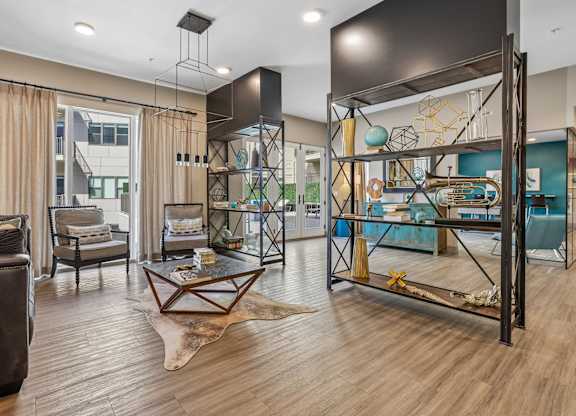 A modern living room with a wooden floor and a large black bunk bed.
