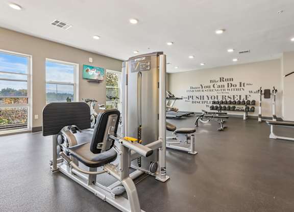 A gym with a sign that says "The Run You Can Do It Yourself Push Yourself Discipline".