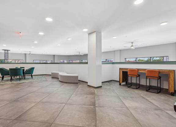 A spacious room with a long table and chairs.