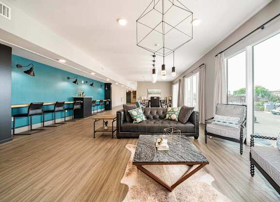 A modern living room with a black leather couch and a wooden coffee table at Crossroads 389 Apartments, Hackensack 07601