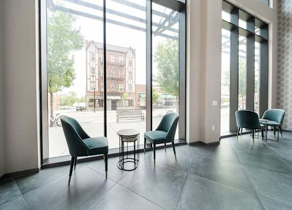 A room with a table and chairs in front of a large window at Crossroads 389 Apartments, Hackensack, New Jersey