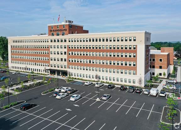 A large building with a parking lot in front of it.