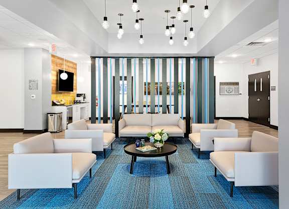 A modern waiting room with a long couch and a coffee table.