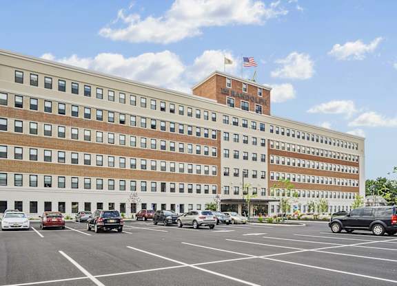 A large building with a parking lot in front of it.