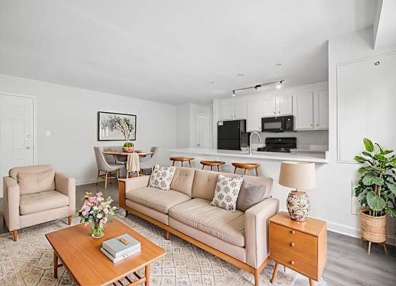 A living room with a couch, chairs, and a coffee table.