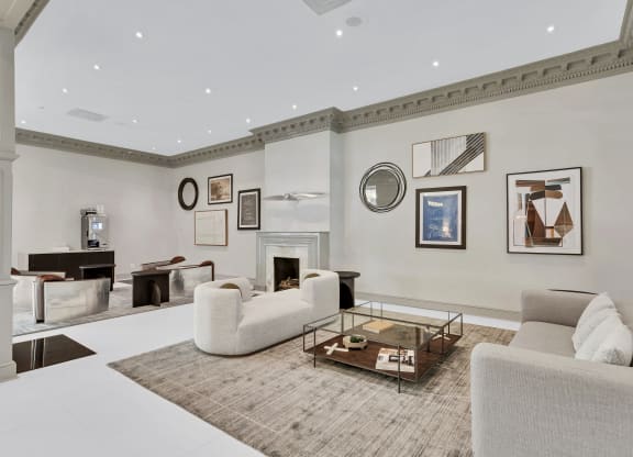 a living room with couches and a coffee table and a fireplace