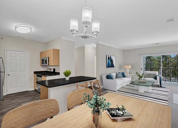 A modern kitchen with a dining table set for four.