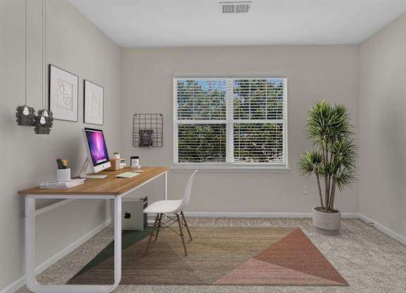 A room with a desk, chair, and a plant.