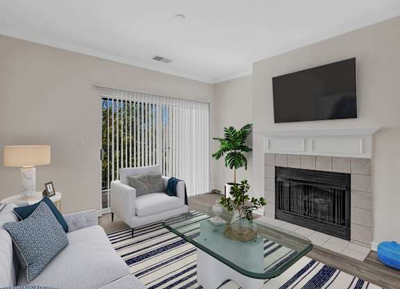 A living room with a fireplace and a television mounted above it.