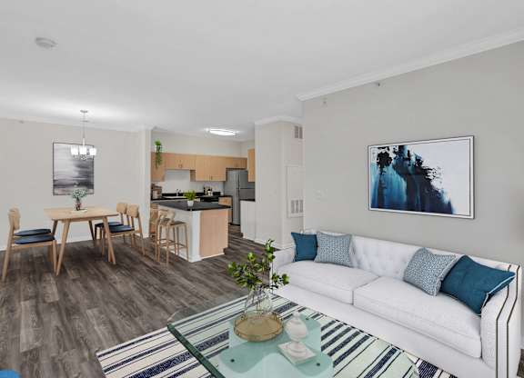 A living room with a white couch and a coffee table in the center.