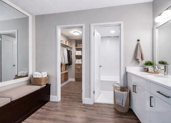 A bathroom with a white vanity and a large mirror.