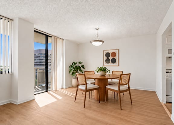 A dining room with a table and chairs.