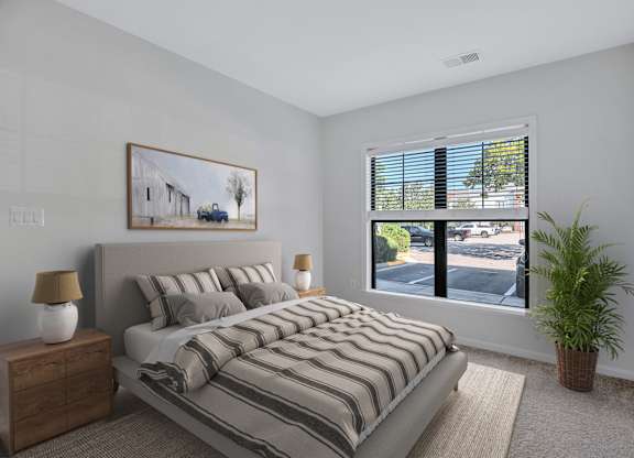 A bedroom with a large bed and a painting on the wall.