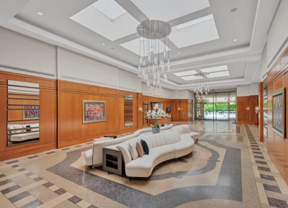 a living room with a white couch and a chandelier