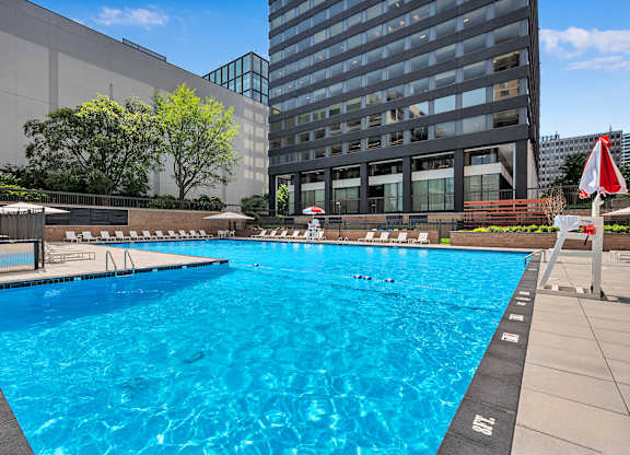 A large blue swimming pool in front of a building.