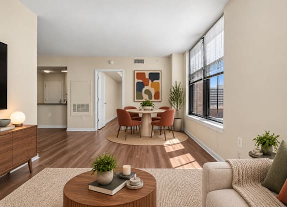 A living room with a brown coffee table and a grey couch.